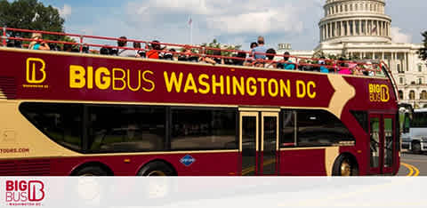 Image of a red Big Bus double-decker tour bus in Washington DC with people on the upper deck. The Capitol building is visible in the background under a clear sky. The bus branding includes the company's name and website.