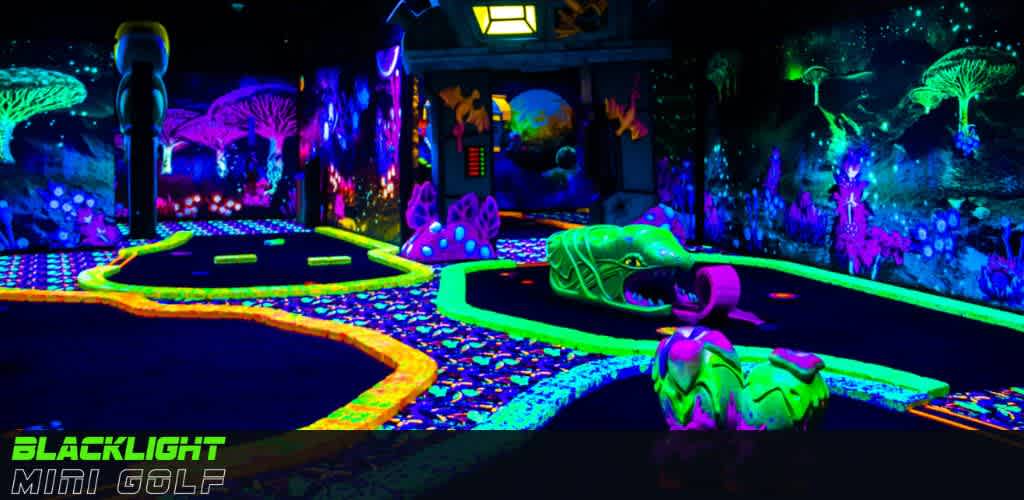 Image Description: An indoor blacklight mini-golf course illuminated with vibrant neon colors. The course features whimsical obstacles like psychedelic mushrooms, a neon caterpillar, and aquatic-themed wall murals, creating an immersive and playful environment for golfers. The words Blacklight Mini Golf are displayed in the foreground.