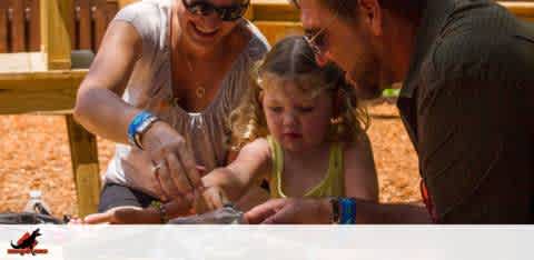 Family enjoying a hands-on activity outdoors together.