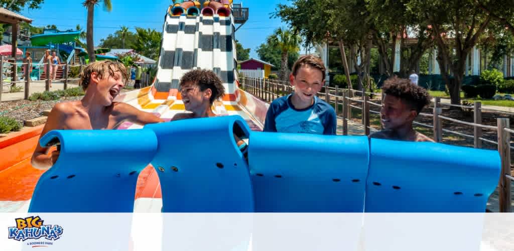 Group of kids having fun after going down a slide at Big Kahuna's Water Park.