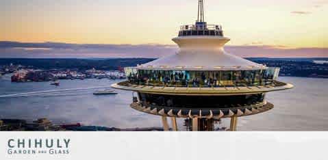 Image shows the upper section of the Space Needle in Seattle during twilight. The observation deck and the rotating glass floor are visible against a backdrop of a dusky sky and distant waters, with faint outlines of land and boats. Below, the text reads 'Chihuly Garden and Glass'.