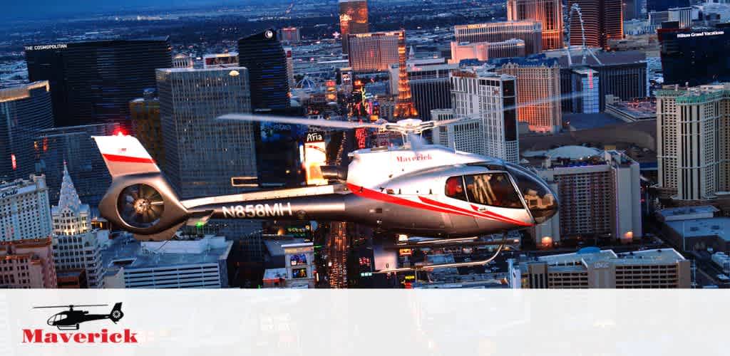 Image shows a helicopter with the Maverick logo flying over a cityscape during dusk. Skyscrapers lit with various lights are visible in the background, suggesting an urban setting. The helicopter is in focus against the sprawling city, illustrating a scenic aerial tour experience.