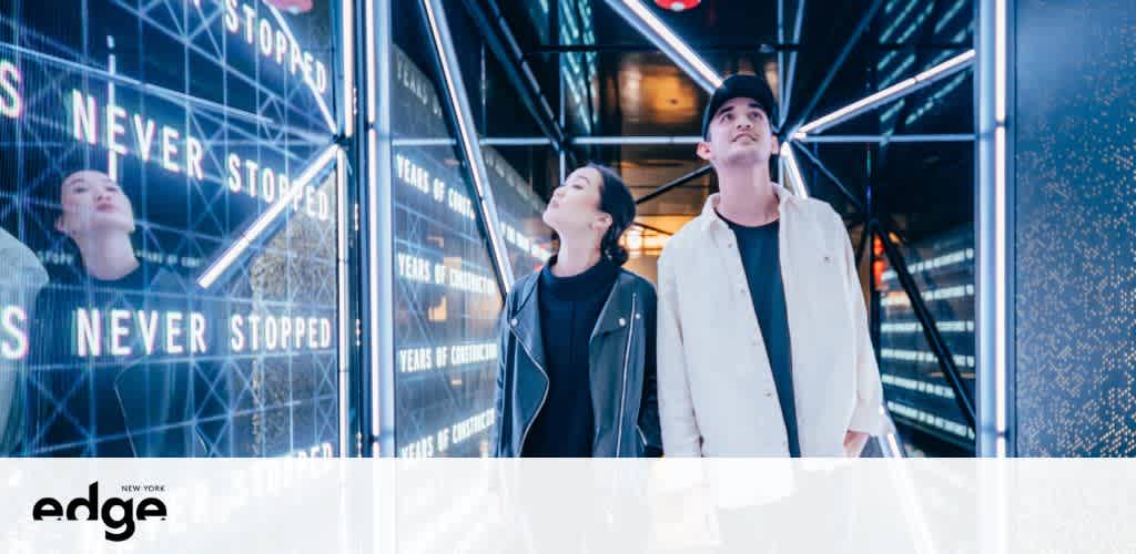 Two people look up in a futuristic room with reflective surfaces and lights.