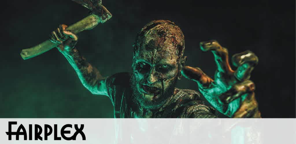 Image depicts a person in theatrical zombie makeup with an eerie greenish hue, reaching out menacingly while gripping a tool. Below is the word FAIRPLEX boldly displayed. The setting suggests a horror-themed event or attraction.