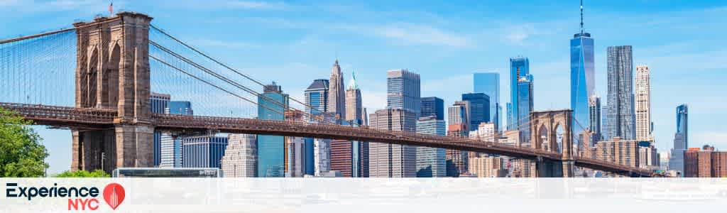 Panoramic view of the Brooklyn Bridge with the New York City skyline in the background. The bridge's iconic stone towers and suspension cables lead the eye towards a cluster of modern skyscrapers under a clear blue sky. The image promotes Experience NYC at funex.com with a logo in the bottom left corner.