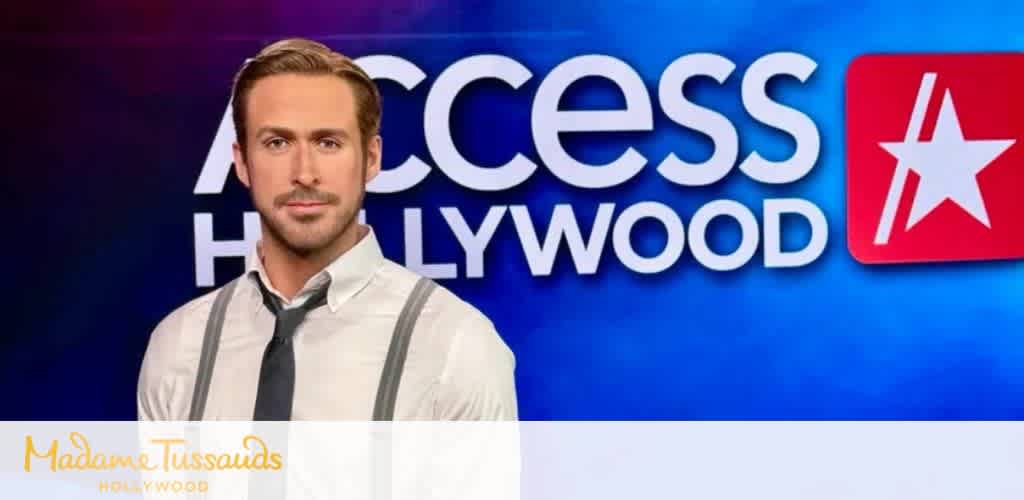 A man in a white shirt and tie standing in front of a colorful Hollywood Access background with a large red star logo.