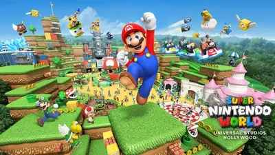 Image of Super Nintendo World at Universal Studios Hollywood. Colorful scene with iconic video game characters in a vibrant, blocky landscape. A character in red and blue overalls jumps triumphantly in the foreground. People enjoy rides and attractions in a playful, imaginative environment featuring castles, hills, and familiar game elements like coins and question blocks. The setting evokes the adventure and excitement of a video game world.