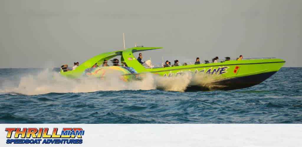 A green speedboat with passengers moving quickly across the ocean.
