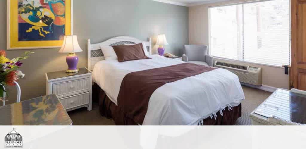 A bedroom with a large bed, white nightstands, purple lamps, and a colorful abstract painting.