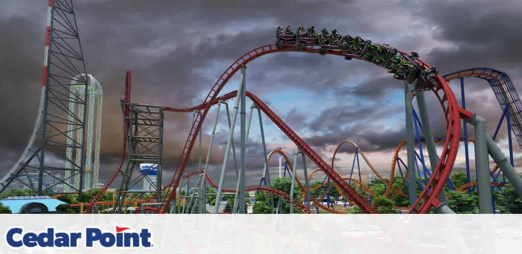 Amusement park with dramatic sky and several roller coasters, including a red one with a train of passengers at the top of a loop.