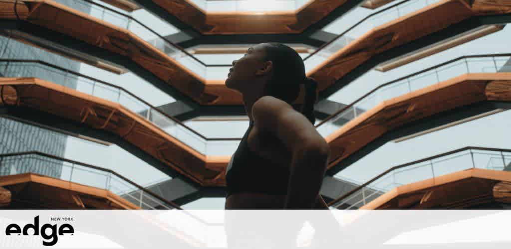 Person looking up against a backdrop of angular staircases.