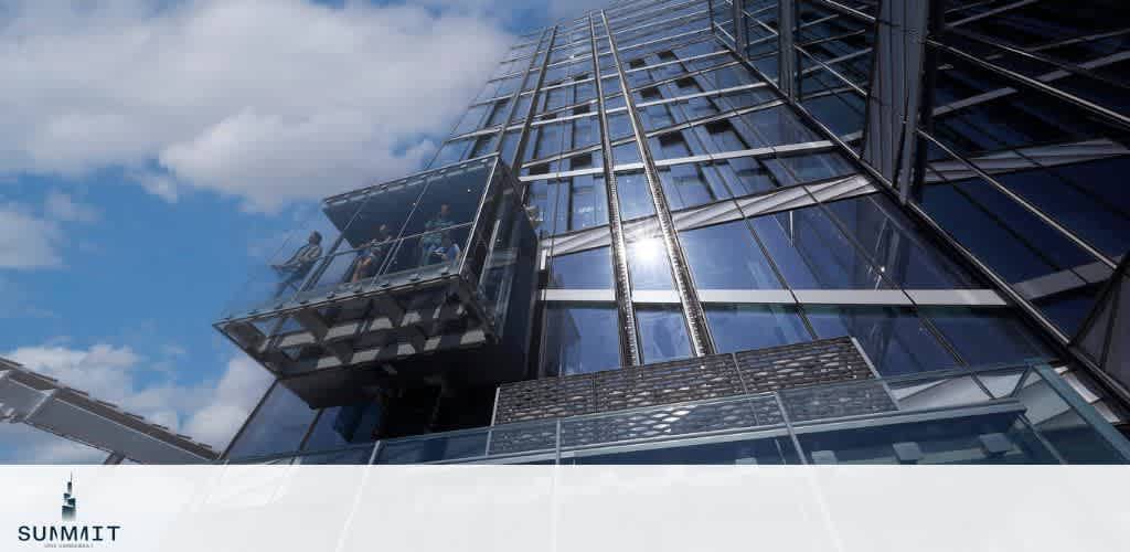 Skyscraper with a glass observation deck under a blue sky.