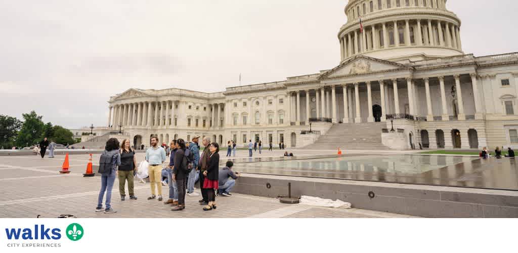 Group of people gathered outside the United States Capitol building on a cloudy day
