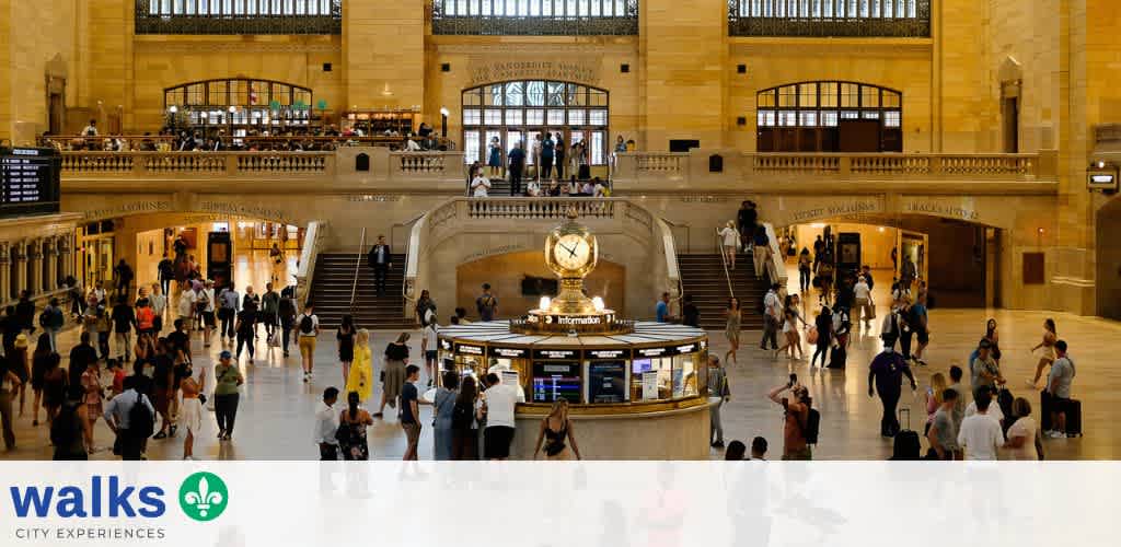 A busy train station with people walking and gathering in a large open space with high ceilings and a central information booth.