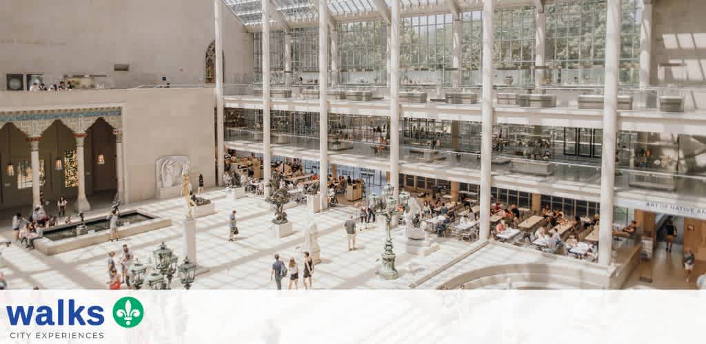 Interior view of a spacious atrium with natural light, multiple levels, seating areas, decorative fountains, and people walking and dining.
