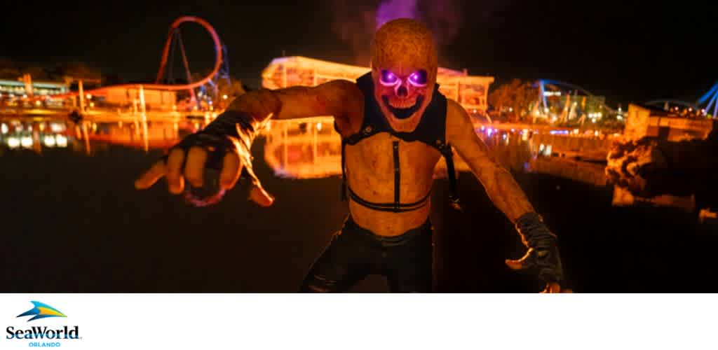 A creature with glowing purple eyes at night in SeaWorld Orlando with an amusement park in the background.