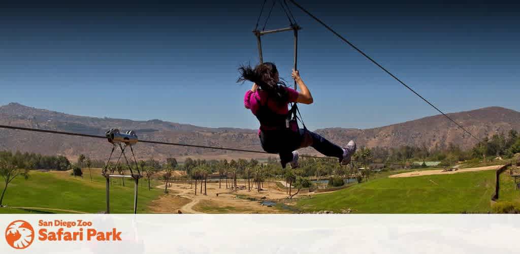 Child on a zip line at San Diego Zoo Safari Park outdoors with mountains and greenery in background