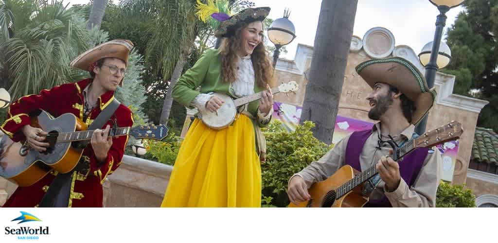Three musicians in pirate-themed costumes play instruments outdoors at SeaWorld San Diego.