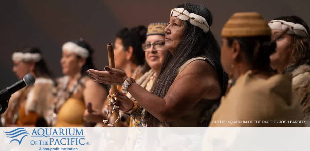 Group of Indigenous women in traditional attire participating in a cultural ceremony outdoor