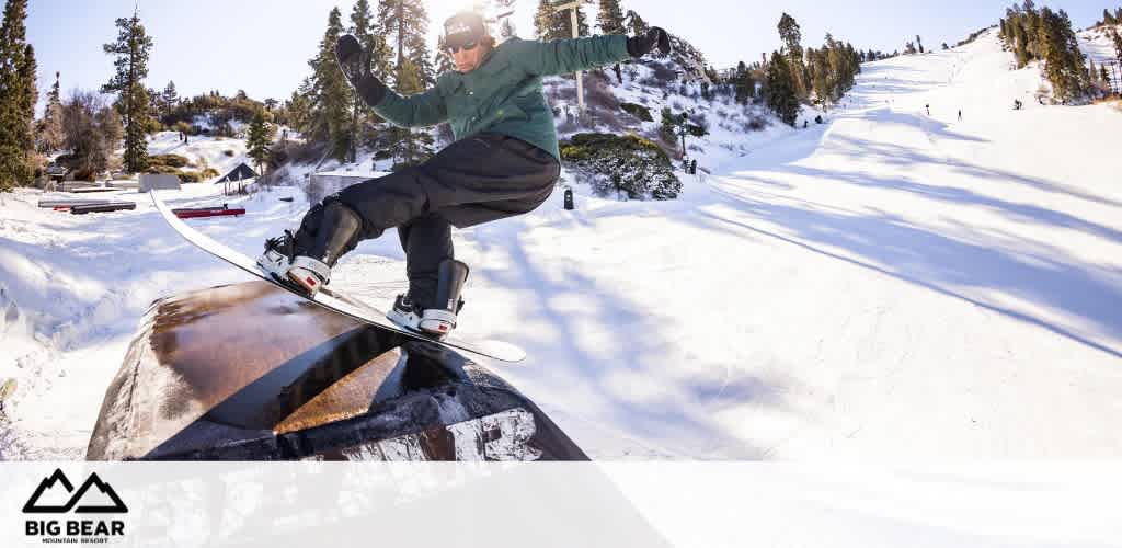 Snowboarder performing a trick on a rail at Big Bear Mountain Resort.
