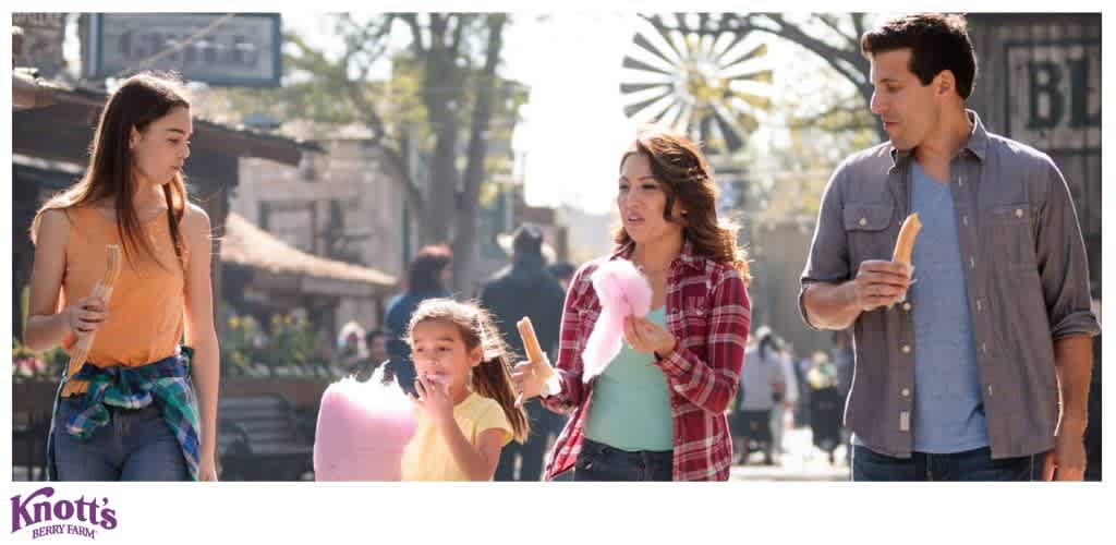 A group of four people enjoying snacks at Knott's Berry Farm.