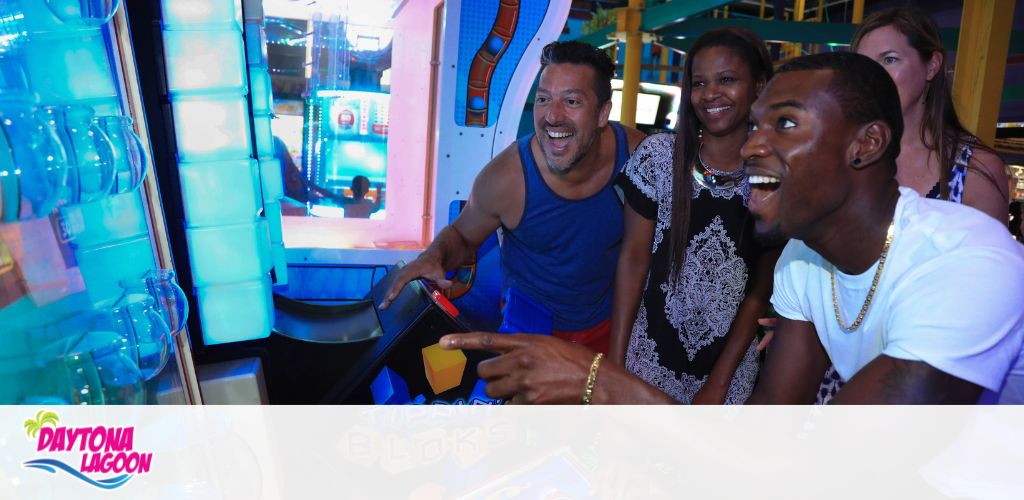 Group of excited people playing an arcade game at Daytona Lagoon.