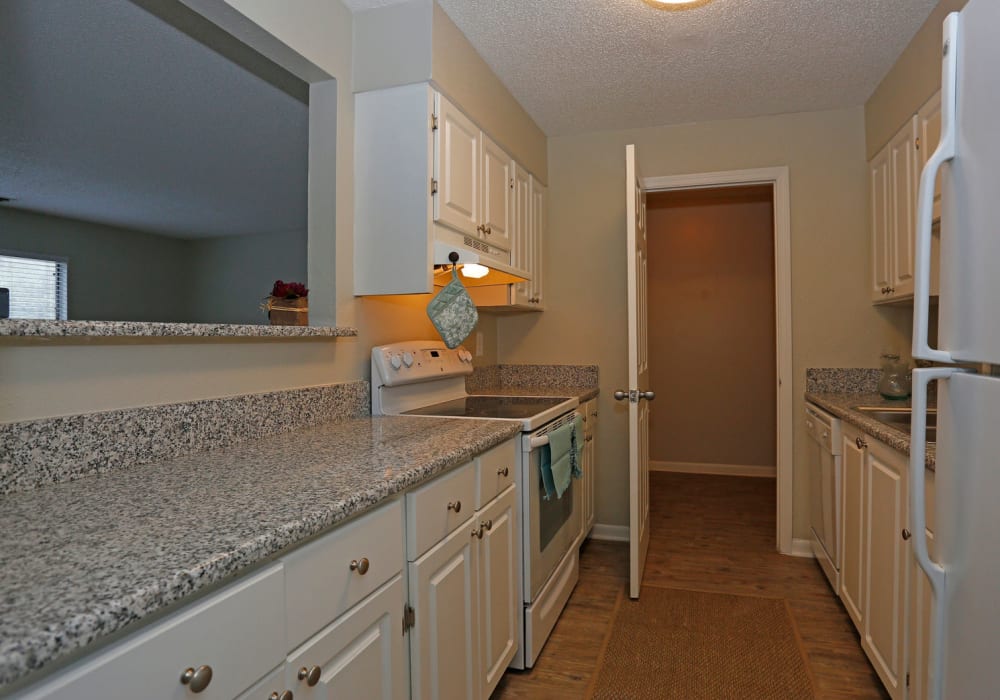 Kitchen with granite counters and white cabinets at Stone Creek in Tampa, Florida