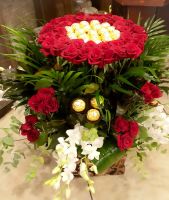 Ferrero Chocolate arrangement with red roses in a nice basket.