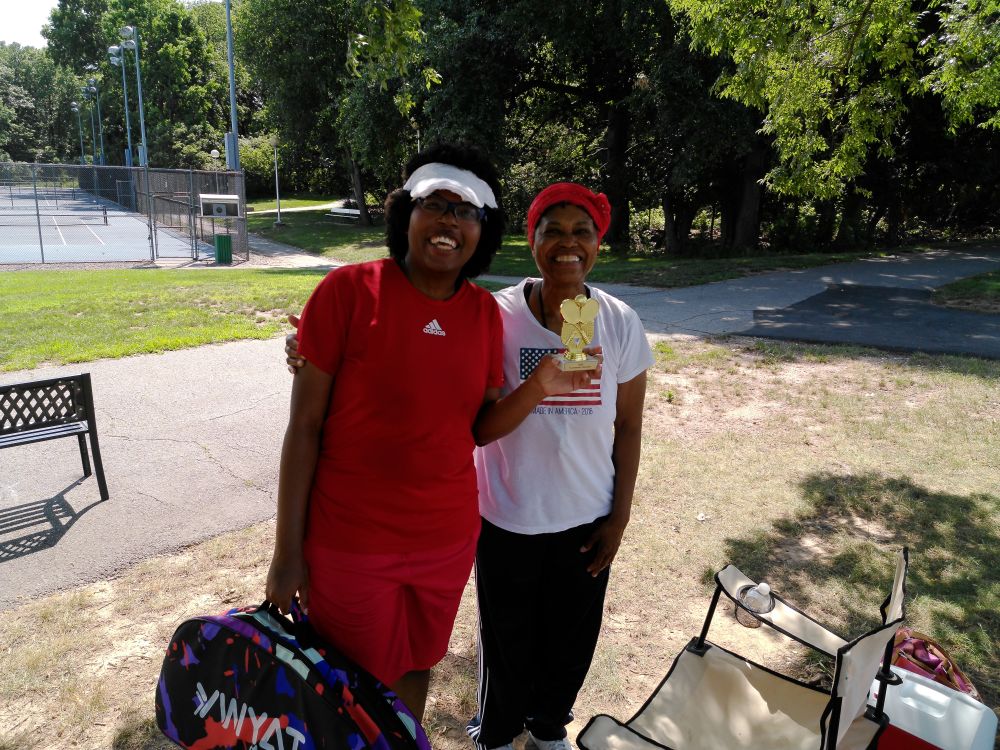 picture of me and my mom with a tennis trophy