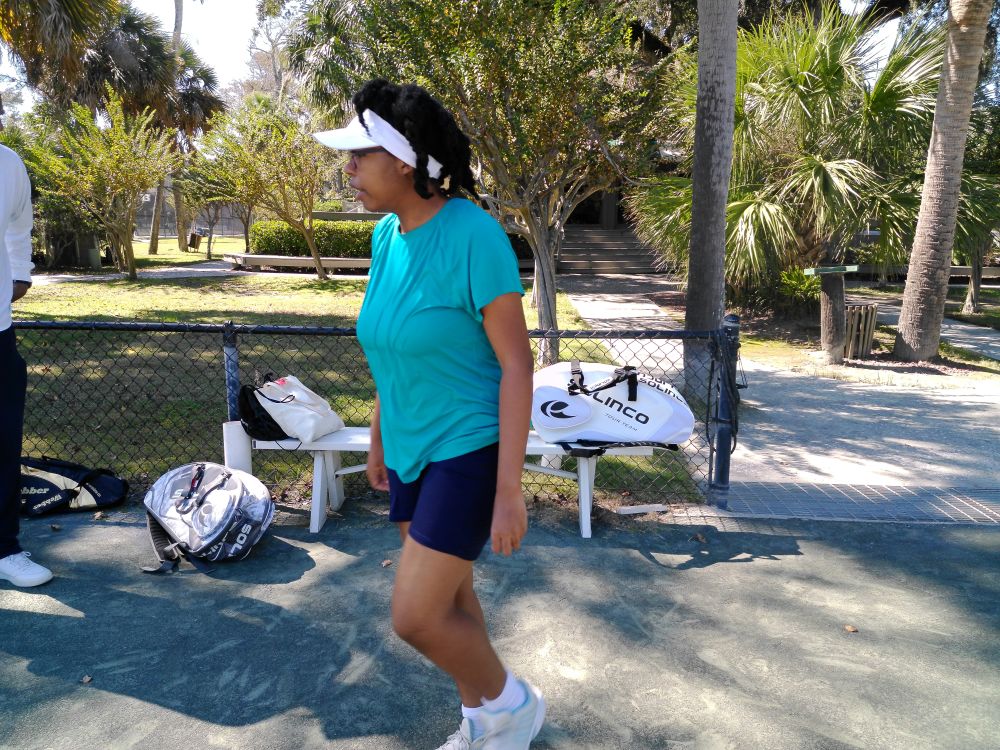 Photo of me walking across the tennis court at the tournament