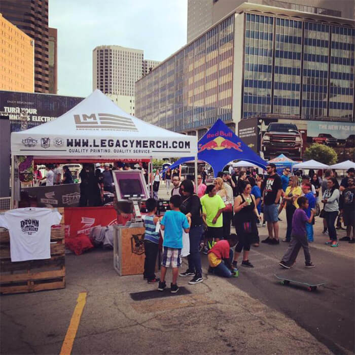 legacy merch at an event in DFW live screen printing