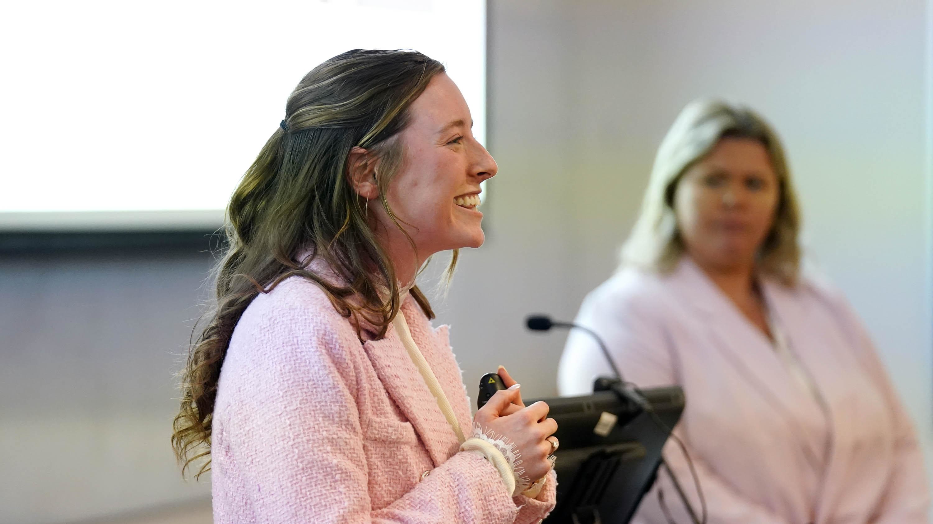 Female bachelor's in business degree student presenting research at GCU