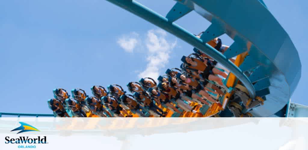 Roller coaster with riders against a blue sky, with SeaWorld Orlando logo at the bottom.