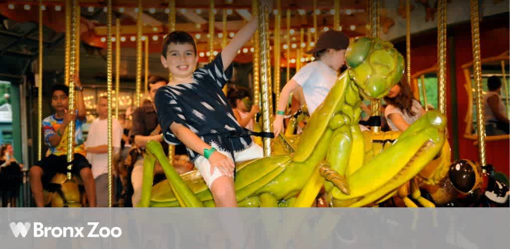 Children riding a carousel at the Bronx Zoo, with a boy on a green praying mantis seat.