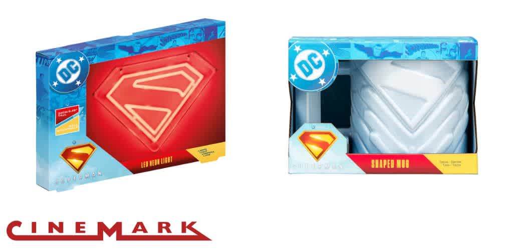 Two boxed Superman-themed products, a neon light, and a mug, with a Cinemark logo below.