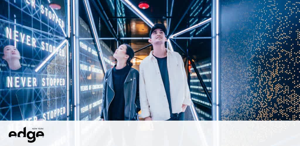 TTwo people walk through a futuristic, reflective corridor with the text