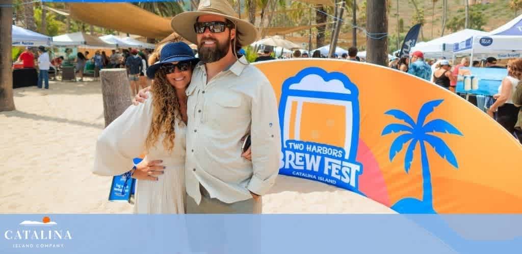 Man and woman posing at the Two Harbors Brew Fest with people and tents in the background.