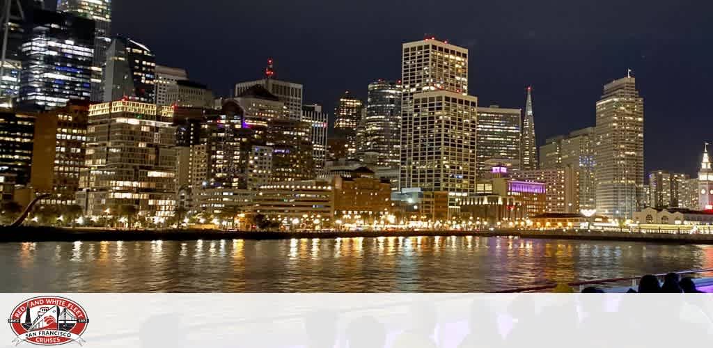 San Francisco skyline at night with city lights reflecting on the water.