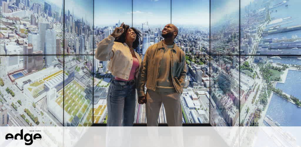Two people stand inside a high-rise building with glass walls that showcase a panoramic view of a cityscape. The individual on the left, wearing a light jacket and jeans, looks up with a hand shading their eyes. Adjacent, a person in a tan jacket gazes skyward, immersed in the urban vista. Logos are visible, indicating a location known as Edge in New York.