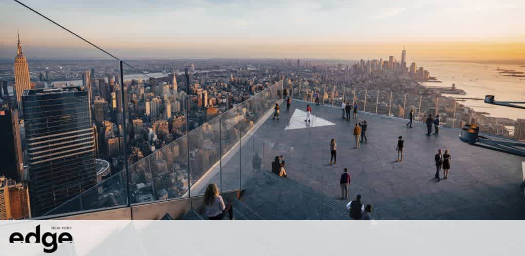 Visitors enjoy panoramic views at the Edge observation deck in New York during sunset. The expansive skyline includes iconic buildings with the river in the background. Clear barriers allow for unobstructed city vistas.