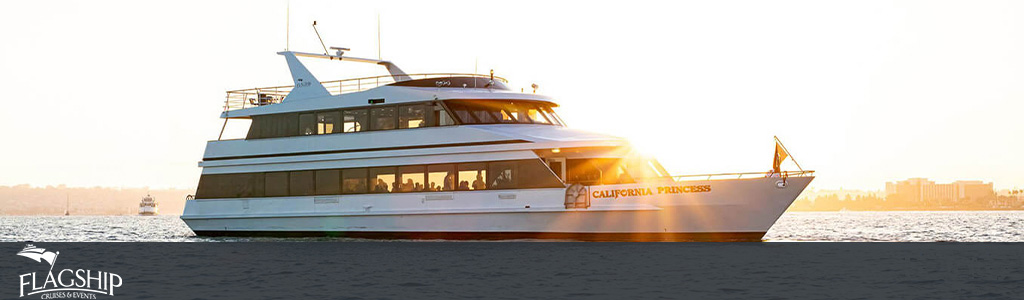 The image displays a large, multi-deck yacht sailing on calm waters during what appears to be sunset. This vessel, named the California Princess, has a prominent white exterior with tinted windows along its sides where passengers can be seen enjoying the views. The yacht is moving from left to right in the image, and the sun is low in the sky, casting a warm golden light across the scene. The yacht's sleek design and the serenity of the surrounding water convey a sense of luxury and relaxation. The word "FLAGSHIP" is visible in the upper left corner, indicating the company operating this cruise. 

Enjoy unforgettable ocean vistas and unparalleled service aboard the California Princess, and remember to visit GreatWorkPerks.com for exclusive discounts and the lowest prices on tickets to the best experiences.