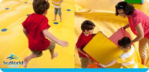 Children play on a colorful indoor playground at SeaWorld San Diego.