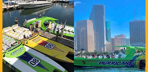 Speedboats docked and one cruising in a city waterfront.