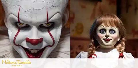 Two wax figures are shown side by side. On the left, a clown with white face paint, red lines on its face, and sharp teeth is displayed. On the right, a female doll with pigtails, wide blue eyes, and a vintage dress appears. Madame Tussauds New York logo is visible.