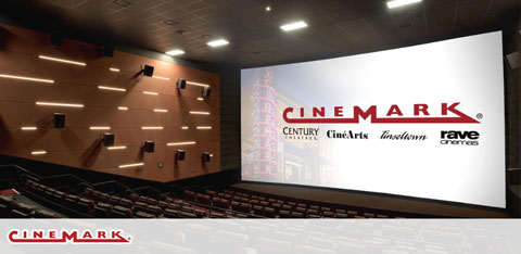 This image displays the interior of a Cinemark movie theater. It features rows of red and black seats facing a large movie screen, which is currently showing the Cinemark logo. The theater appears to be empty, awaiting an audience. The walls are adorned with decorative acoustic panels, and the floor is carpeted in a dark color, which compliments the aesthetic of the room. Lighting gently illuminates walkways and rows for visibility and safety. 

***

To enhance your entertainment experience without breaking the bank, visit GreatWorkPerks.com for the lowest prices and significant savings on tickets to venues like this and many more.