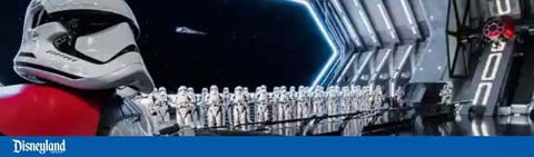 A group of stormtroopers lined up inside a spacecraft corridor.