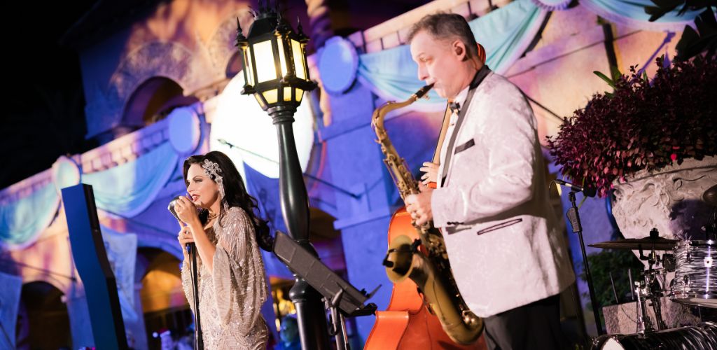 A man and woman playing saxophones together, creating music in a lively and engaging atmosphere.