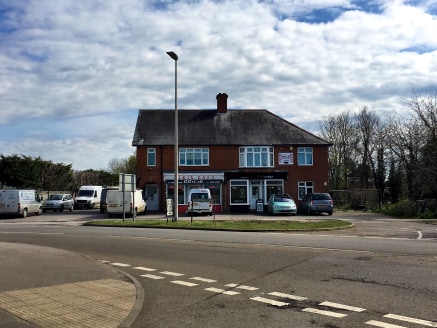 The property comprises 2 retail units with 2 2-bedroomed flats above. The property also includes a gravel yard area to the side with large parking area to the front and gardens to the rear.

The total site area is 0.33 Acres.