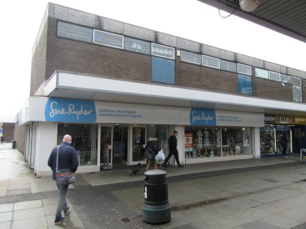 The property comprises a two storey end terraced, double fronted retail unit with upper floor ancillary accommodation currently occupied by Sue Ryder. 

The property is of concrete framed construction with brick elevations set beneath a flat concrete...