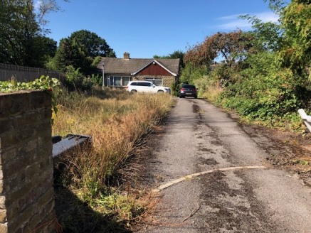The plot is positioned on Bells Hill directly opposite a bus stop, within walking distance of the village centre which has various amenities such as a pharmacy, Costa Coffee, Co-Op and Doctors Surgery. The plot currently consists of a detached bungal...